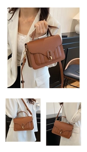 Detail of caramel leather bag with golden oval twist lock and vertical stitching pattern