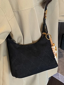 Classic black quilted suede hobo bag with vintage beaded charm and gold hardware