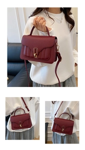 Detail view of burgundy small square bag with lychee texture and gold metal buckle