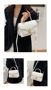 Detail of white lychee pattern leather handbag featuring elegant gold oval twist lock