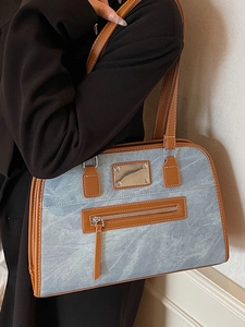 Blue denim and brown leather trim shoulder bag with adjustable strap in casual style