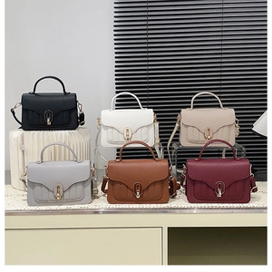 Array of six small square handbags in various colors with elegant golden twist locks
