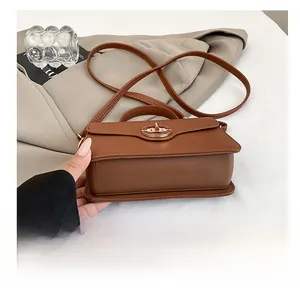 Détail du fond résistant à l'usure d'un sac bandoulière en cuir marron texturé