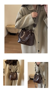 Detail of retro dark brown leather bucket bag with patterned woven shoulder strap