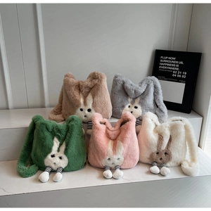 Collection of plush bunny bucket bags in multiple colors with hanging striped legs