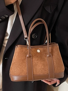 Chic caramel brown suede bucket bag with round metal buckle and shoulder strap