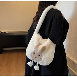 Close-up of fluffy white plush bucket bag with cute bunny design and striped legs detail