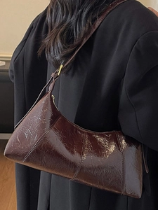 Deep brown glossy patent leather hobo shoulder bag with a vintage wrinkled texture