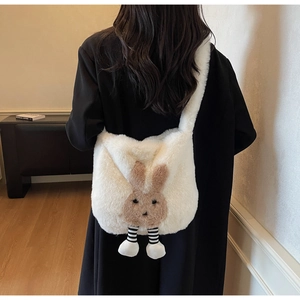 Detail of cute plush bunny bucket bag with striped legs on female model back