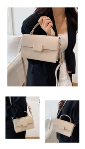 Detailed macro view of cream litchi texture bag with luxury golden square buckle