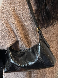 Chic black glossy baguette underarm bag with vintage wrinkled texture and gold buckle