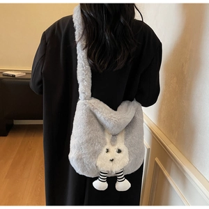 Detail of plush grey bunny bucket bag showing soft faux fur texture and long striped legs