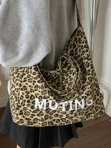 Leopard print canvas tote bag featuring large MUTING text print for daily casual use