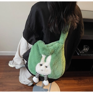 Detailed close-up of fuzzy green plush rabbit bucket bag showing soft faux rabbit fur texture