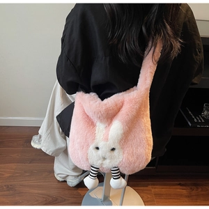Detail view of pink plush bucket bag with cute rabbit ears and 3D striped legs