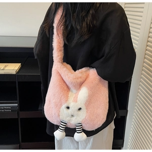 Detailed view of plush pink crossbody bag with 3D bunny ears and legs on a female model