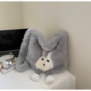Detailed view of gray plush bunny bucket bag in a stylish minimalist setting