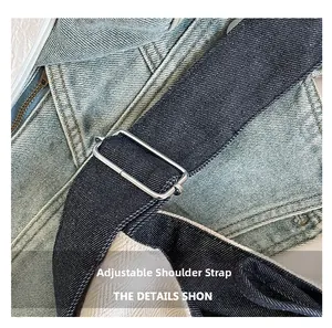 Macro detail of the adjustable denim shoulder strap with durable metal buckle on a tote bag
