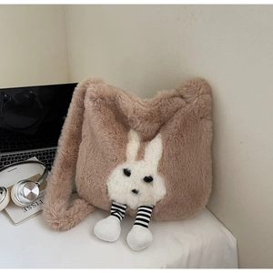 Close-up of the plush brown bucket bag featuring a cute white rabbit with striped legs