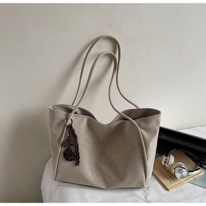 Detail view of large capacity vintage tote bag in beige PU leather with soft wrinkled texture