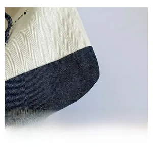 Detail of high-quality herringbone canvas and blue denim patchwork on tote bag
