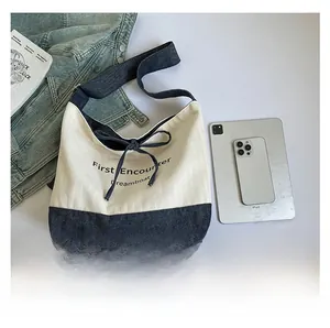 Detailed top view of canvas tote bag showing size scale with iPad and notebook