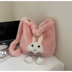 Close-up of a pink plush rabbit bucket bag with fluffy faux fur and cute striped legs