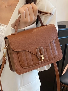 Brown litchi grain vintage handbag with gold clasp and adjustable shoulder strap