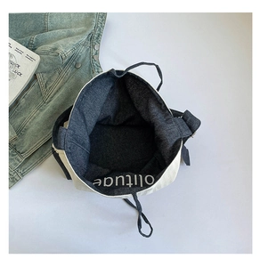Top view of large capacity canvas tote bag showing interior denim and printed lettering