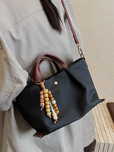 Chic black pleated canvas crossbody bag with vintage wooden bead charm and leather handles