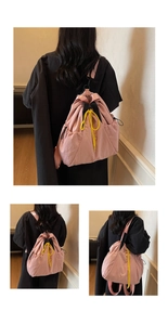 Detailed close-up of pink drawstring backpack featuring contrasting yellow ropes and nylon texture
