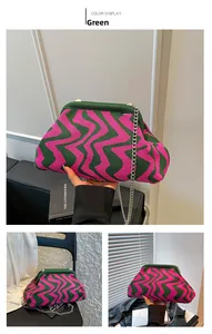 Detail of green and pink wave knit crossbody bag with silver chain and clasp closure