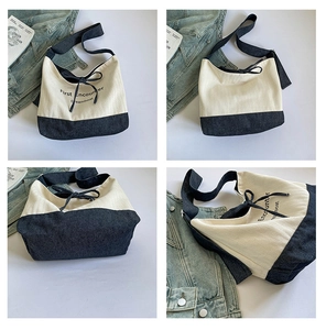 Detail view of canvas tote bag with drawstring closure and printed English typography
