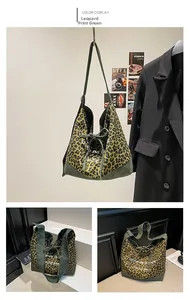 Close-up of leopard print canvas and green suede stitching on this large tote bag