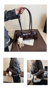 Close-up of dark brown glossy Boston bag featuring a cute beige bear plush pendant