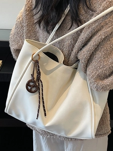 Minimalist cream white tote bag with pretzel charm for daily office and leisure use