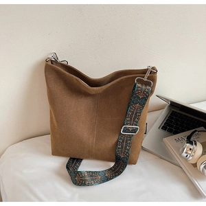 Detail of hobo bucket bag with a bohemian ethnic pattern wide shoulder strap