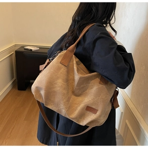 Detail shot of the large vintage canvas tote bag with adjustable shoulder strap and logo