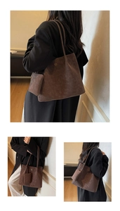 Close-up of brown suede tote bag featuring gold logo and matching mini pouch accessory