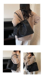 Detail view of large black tote bag with matching coin purse and gold lettering