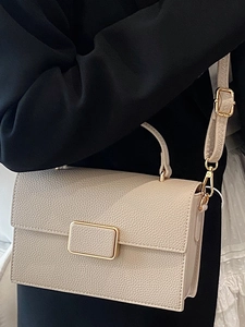 Chic beige crossbody bag with pebble texture and elegant gold metallic buckle