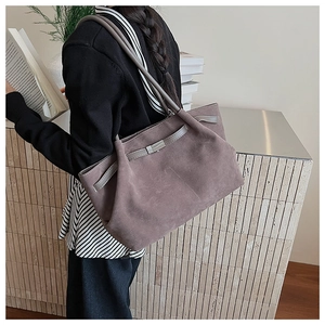 Detail view of large dark brown frosted suede shoulder bag with sleek silver buckle finish