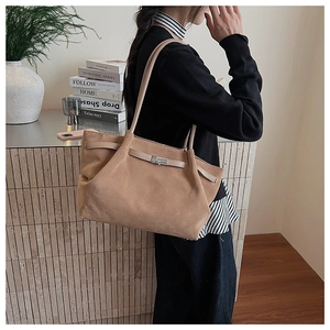 Detail of light brown matte suede tote bag featuring silver metal buckle and large capacity