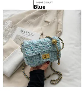 Close-up of light blue tweed shoulder bag with gold hardware and elegant chain strap