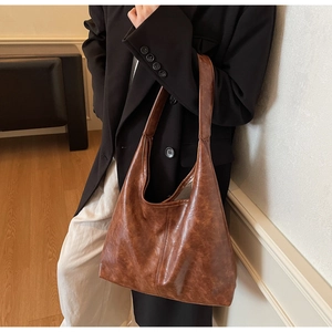 Detail view of dark brown retro tote bag showing rich oil wax leather texture and large capacity