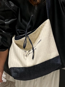 Minimalist canvas and denim patchwork tote bag with First Encounter print and drawstring detail