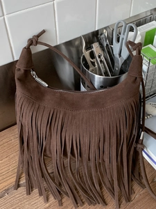 Fashionable dark coffee suede crescent shoulder bag with long fringes and zipper