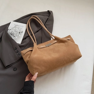 Macro shot of brown frosted texture and metal buckle detail on casual bucket bag