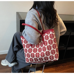Detail of red leather strap and metal rivet on canvas tote with Double Happiness pattern