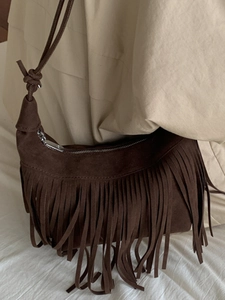Minimalist brown suede tassel crossbody bag with fringe detail and shoulder strap